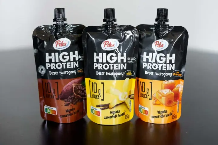 Trzy opakowania napoju proteinowego Pilos z Lidla: czekoladowy, waniliowy i solony karmel.